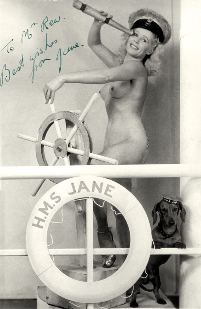 A naked Christabel Leighton-Porter with her dog Fritzi aboard H.M.S. Jane.